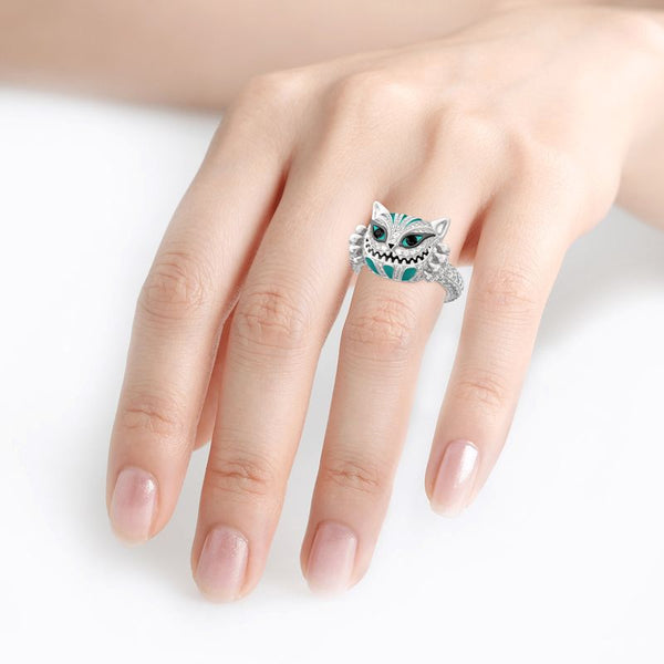 This stylish and timeless ring features an intricate Cheshire Cat design set into a sterling silver band. Crafted with attention to detail, this piece is an expertly crafted and unique accessory to add to any outfit. Its thoughtful design and careful craftsmanship provide a look that is both elegant and eye-catching.