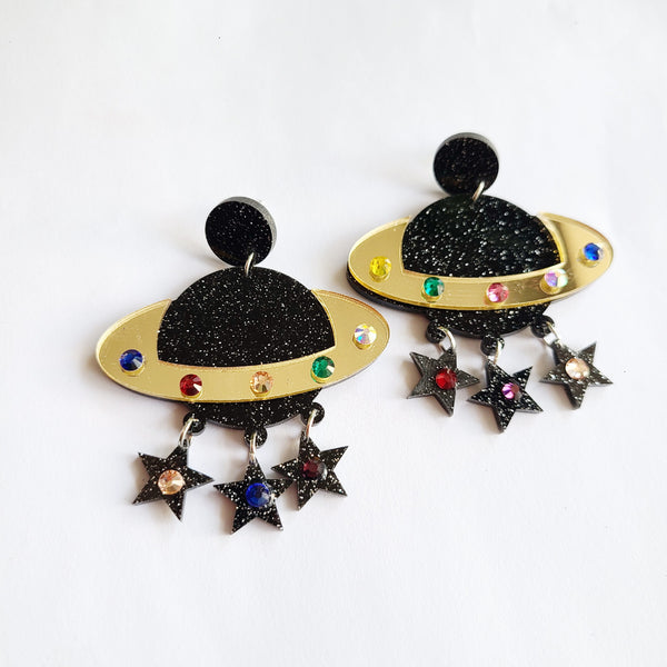 These Cosmic Tassel Acrylic Saturn Earrings are the perfect accessory to elevate any outfit. They are made from high-quality acrylic, making them lightweight and comfortable to wear. With playful tassel details and a bold, eye-catching design, these earrings are sure to turn heads.